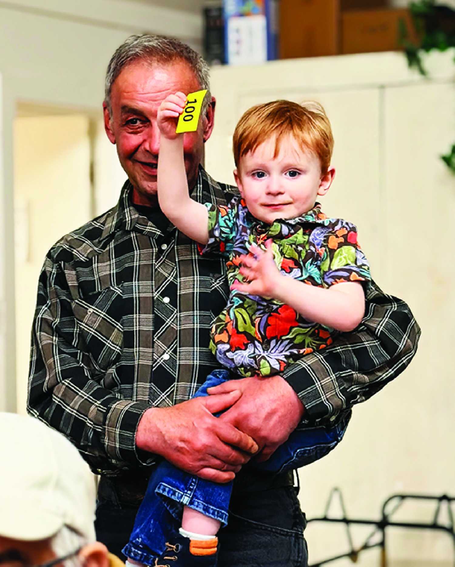 Corbin Stonehouse was one of the bidders in the kids� auction portion at the Fleming Pie Auction on April 11 with some help from his grandpa Alex Hattum
